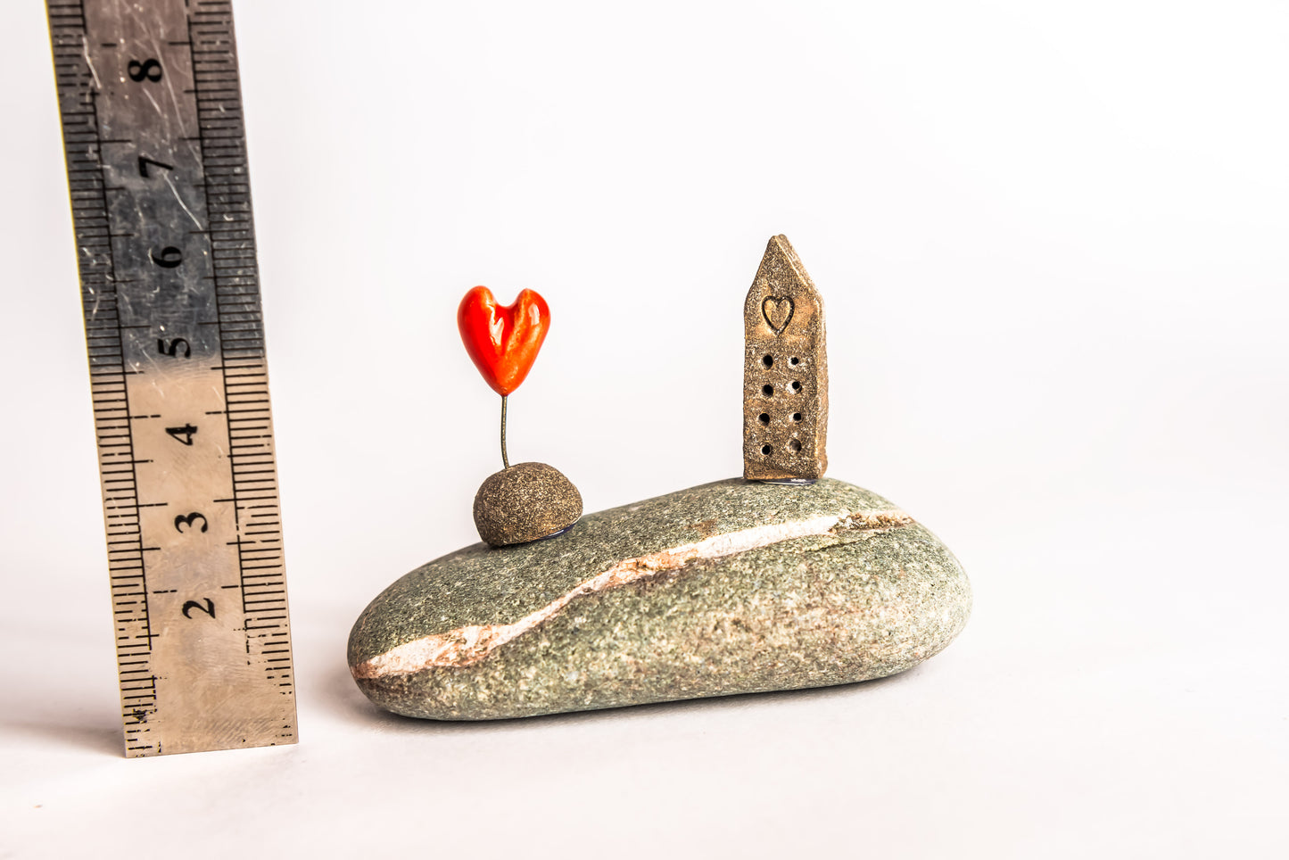 Hand-built brown ceramic house on a rock